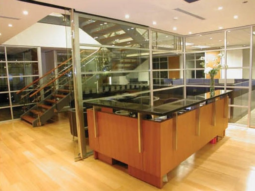 Multi-level office with orange curved reception desk and mezzanine