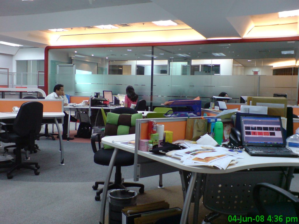 Collaborative open office with orange partitions and green task chairs