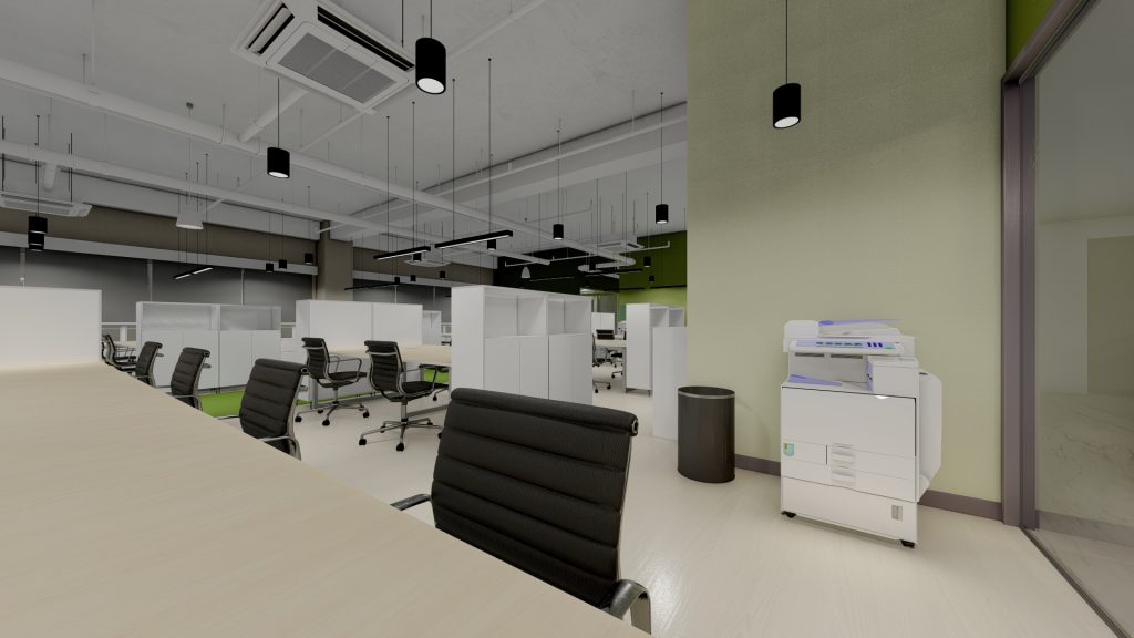 Open-plan workstation area with white partitions and dark office chairs