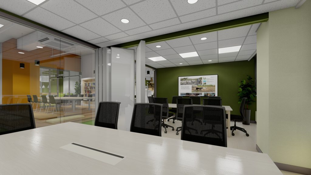 Conference area with black chairs, green wall, and glass partition