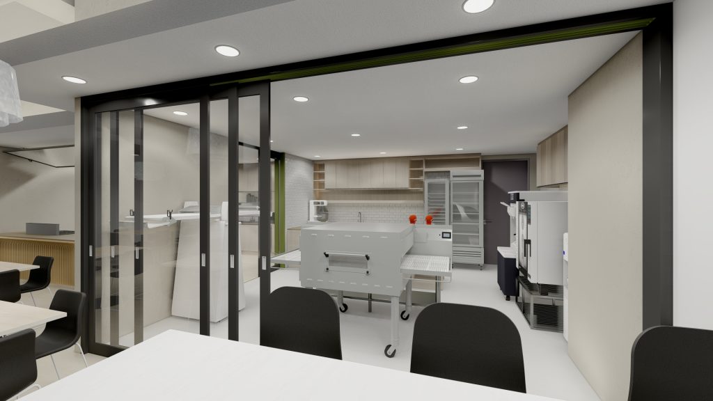 Office kitchen with white cabinetry, pendant lights, green accent wall