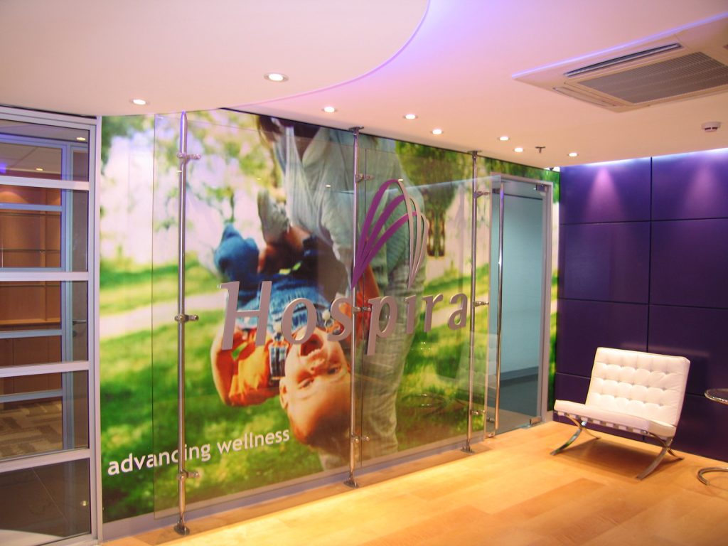 Reception area with branded glass partition and purple accent wall