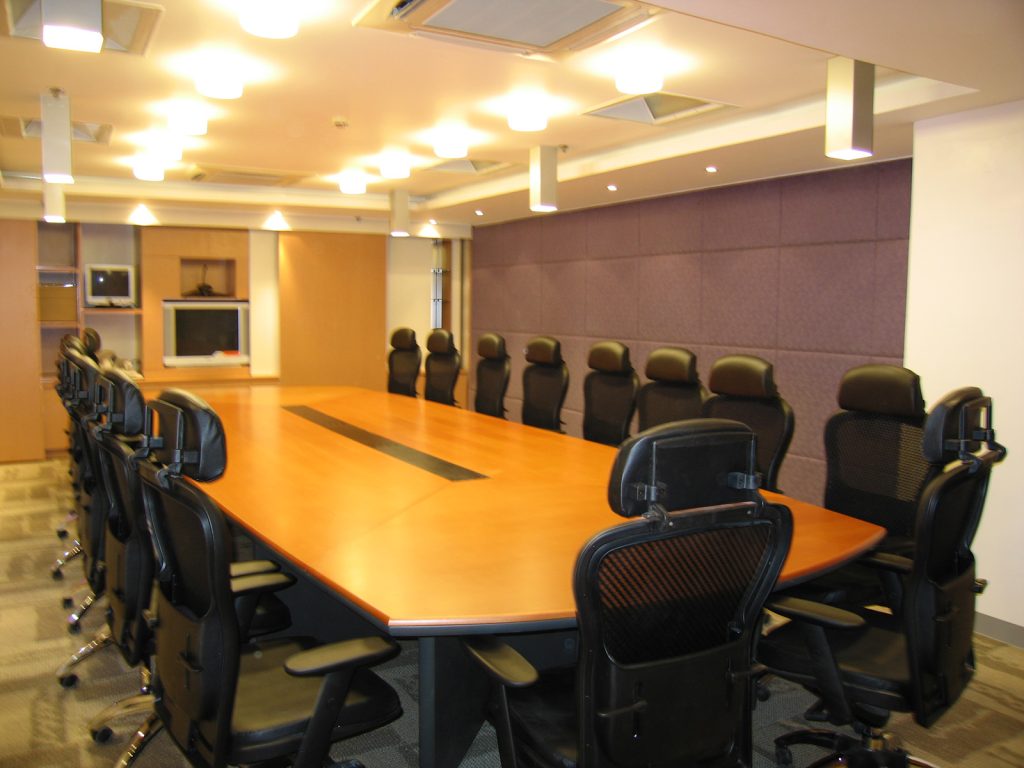 Conference room with orange table and mesh office chairs