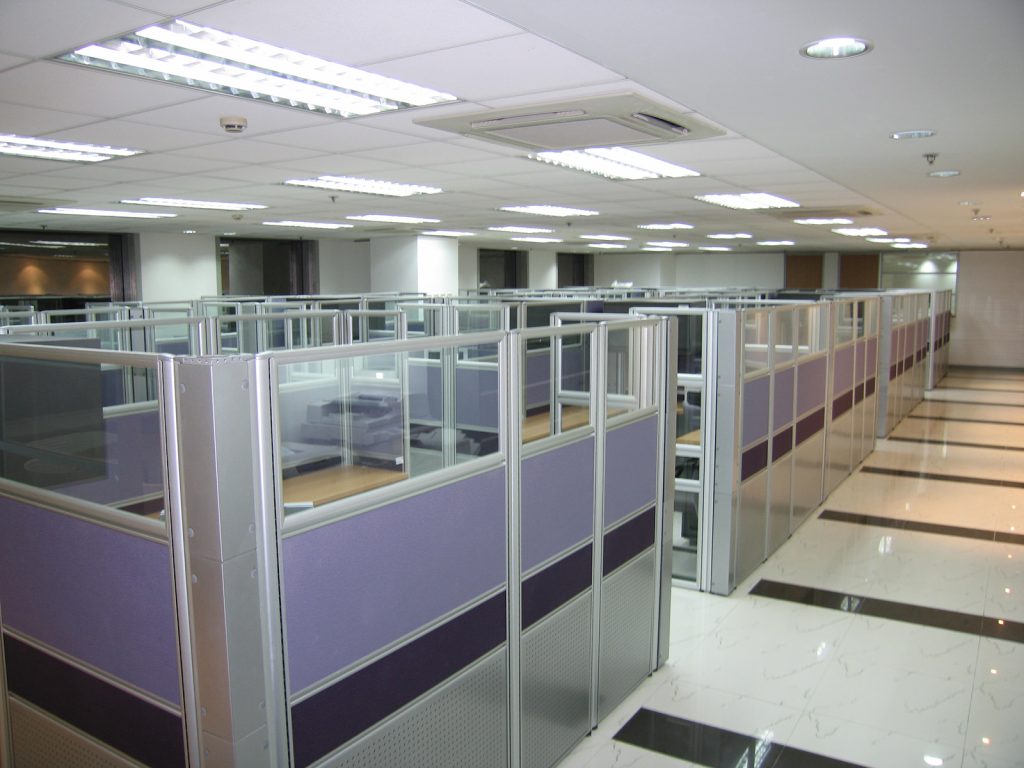 Open office floor with modular purple and glass workstations